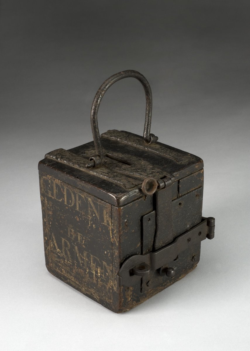 An antique wooden alms box for collecting donations